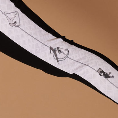 close-up of print on Signature Aerial leggings, focus on a male figure doing rope, a female doing aerial moon, and a female of colour doing pole in heels