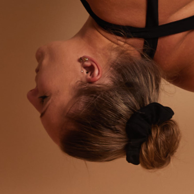 close-up of a hairbun with the scrunchie, shows how the hair is perfectly held in place upside down